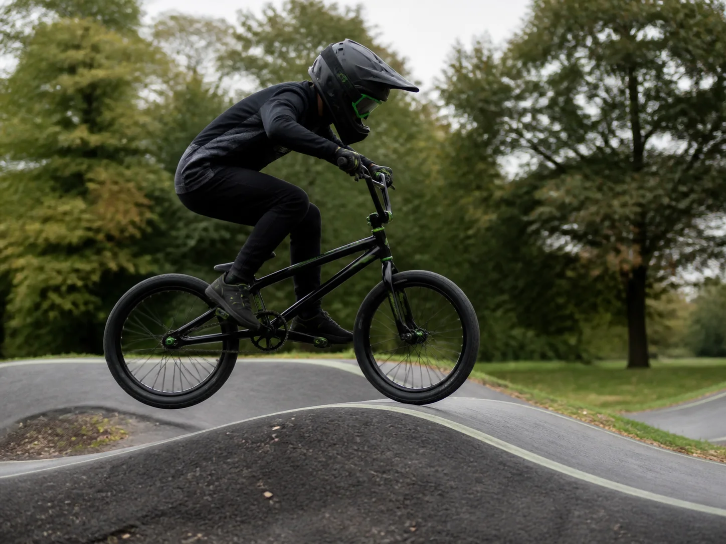 A BMX rider moving at speed around the track
